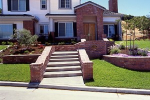 All Brick Walls and Pillars with Exposed Aggregate Walkway and Steps